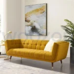 Yellow velvet 3-seater sofa with brass legs and tufted design.