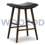 Union saddle stool with warm wood frame and saddle-style seat by Woozod Furniture.